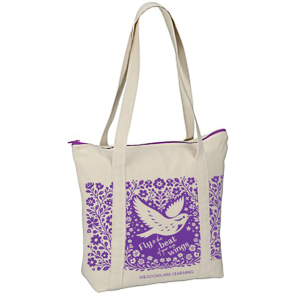 Tote bag with purple floral and bird design on a white background. Fly to the beat of your own wings.