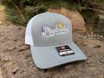 Gray and white cap with 'Meadowlark Learning' logo on a stone surface