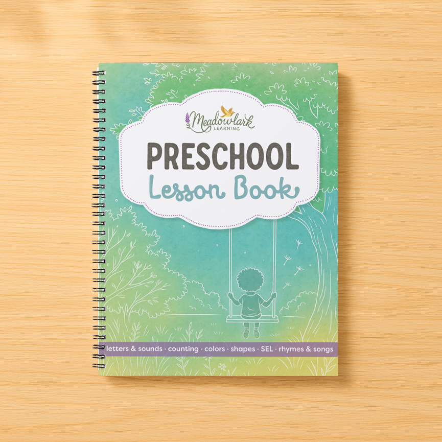 Preschool lesson book on a wooden surface