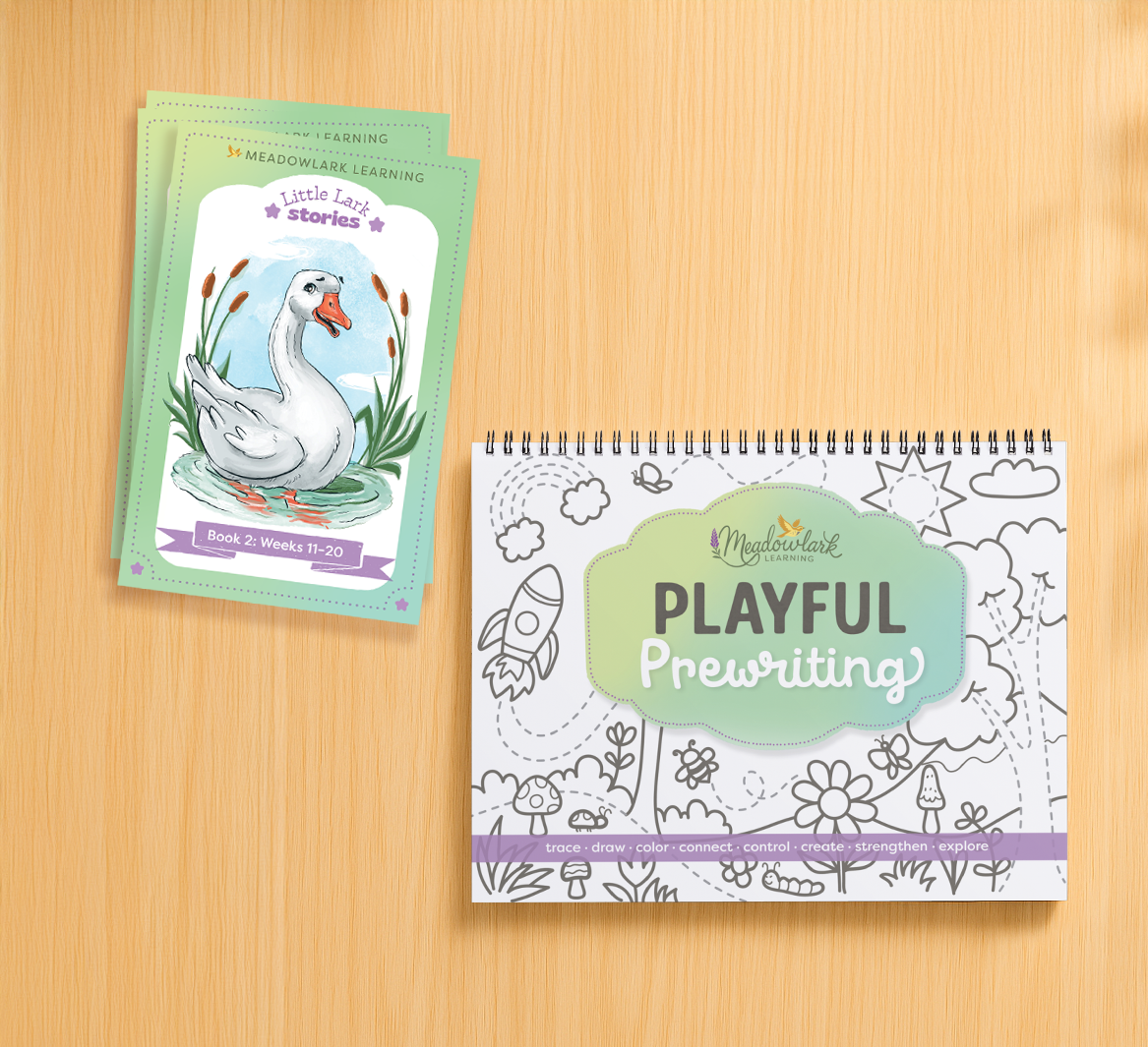 Educational materials including a book and a spiral-bound workbook on a wooden surface